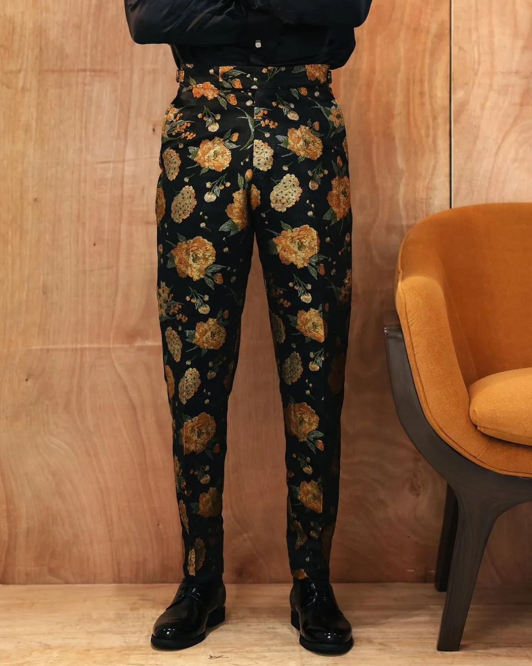 A yellow, silk black jacquard pants with a splash of gold print.