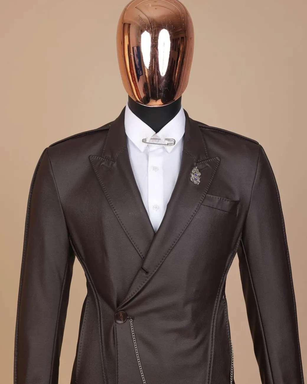 A #Herd” brown leather, knitted & outer layered peak lapel wrap suit