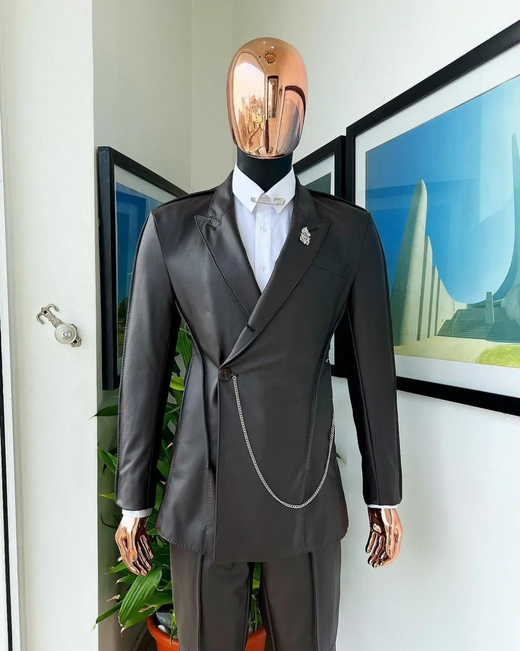 A #Herd” brown leather, knitted & outer layered peak lapel wrap suit