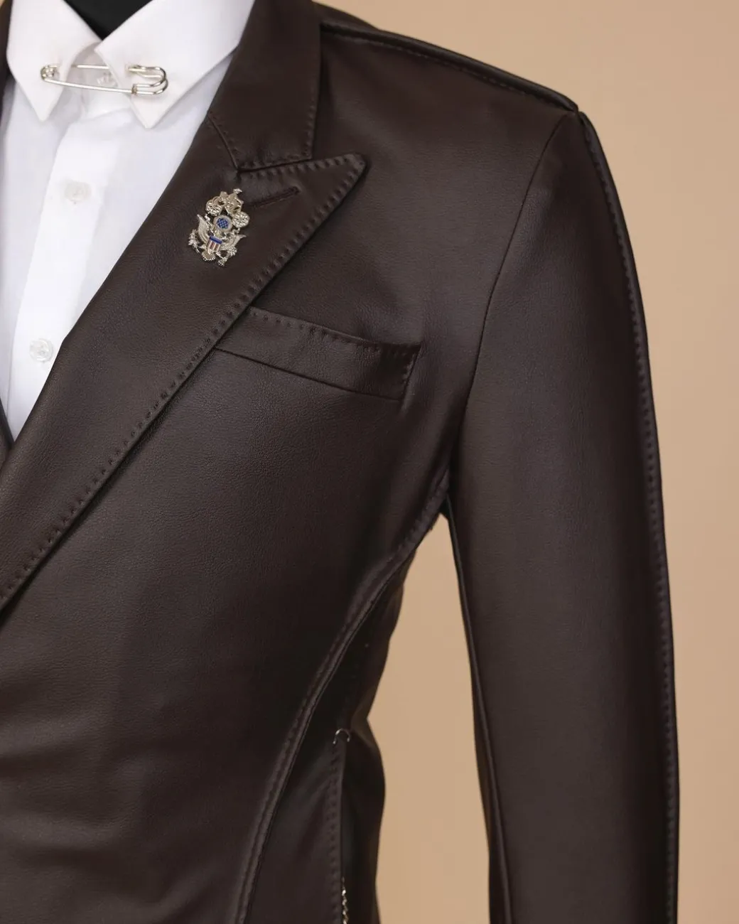 A #Herd” brown leather, knitted & outer layered peak lapel wrap suit