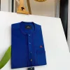 An Admiral Blue, clear view blue Swarovski buttons, edge embroidery, pocket details African traditional senator kaftan native.