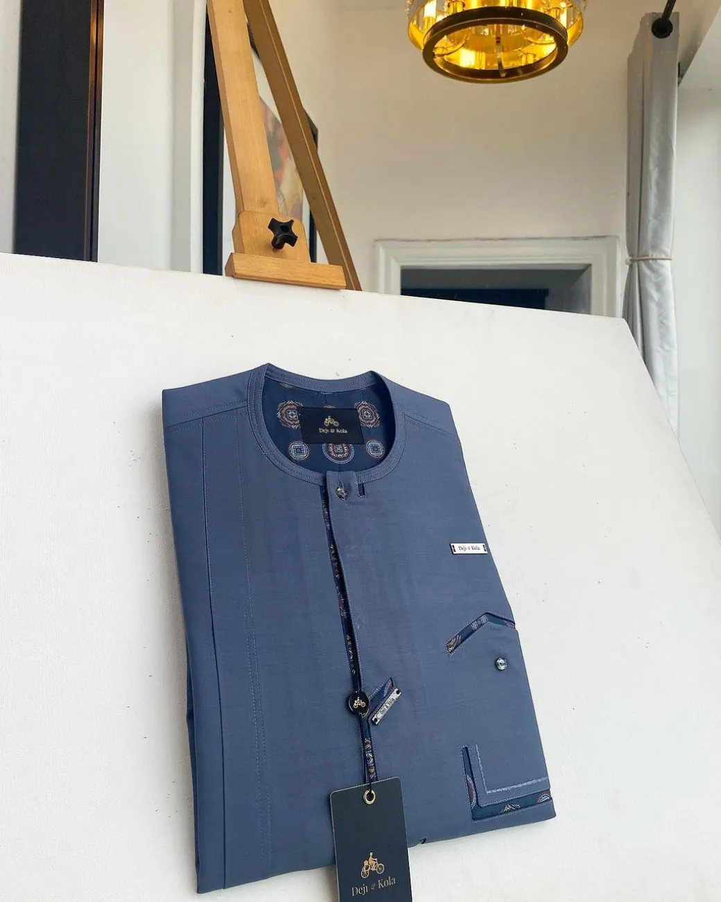 An air-force blue strap and roof pocket, single button front flap Kaftan