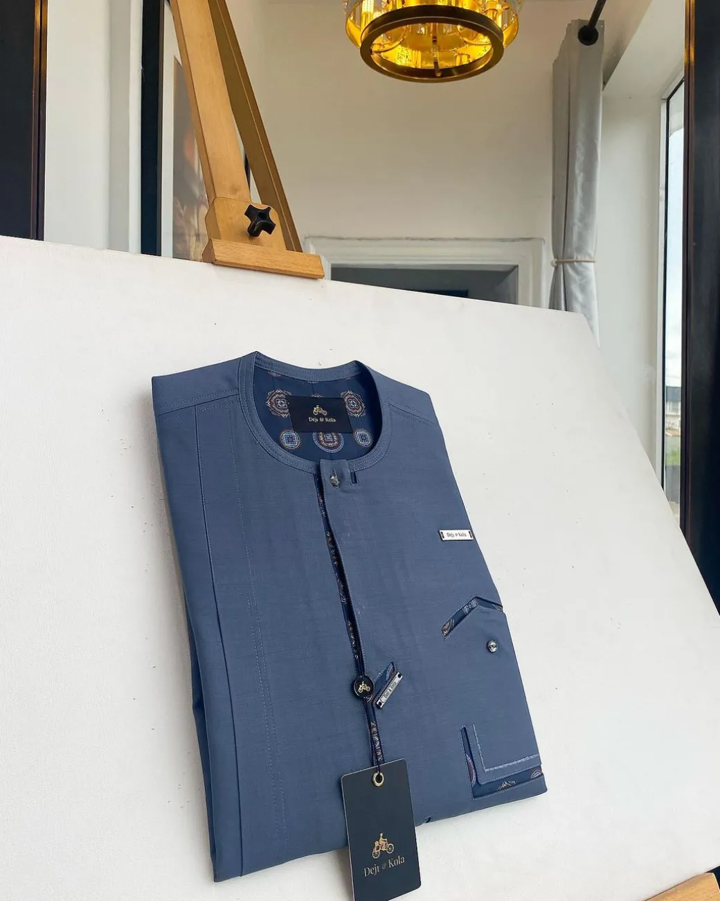 An air-force blue strap and roof pocket, single button front flap Kaftan