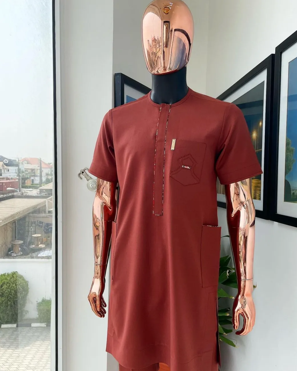 An Amber orange, paisley mountain top patch pocket detailing African traditional senator Kaftan native.