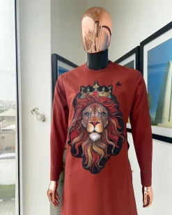 An Amber-orange piped neckline with a 3D lion king head patch stitched embroidery detailing African traditional senator kaftan native.
