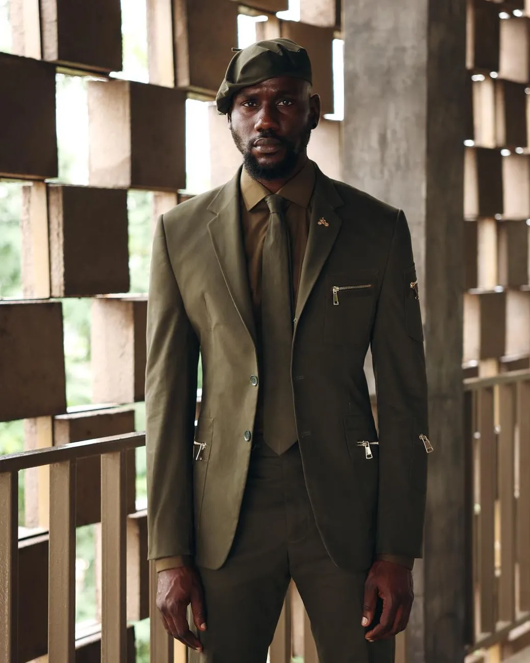 An Army Green Monochrome “Junta” Notch Lapel Suit With Patch Pocket Zip Detailing & Gurkha Pant Trousers.