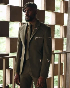 An Army Green Monochrome “Junta” Notch Lapel Suit With Patch Pocket Zip Detailing & Gurkha Pant Trousers.