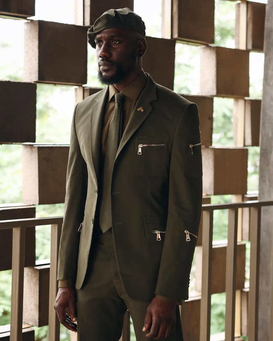 An Army Green Monochrome “Junta” Notch Lapel Suit With Patch Pocket Zip Detailing & Gurkha Pant Trousers.