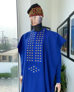 An Azure blue, connected square embroidery design with gold treading & matching Swarovski stone details agbada