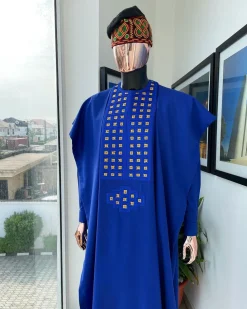 An Azure blue, connected square embroidery design with gold treading & matching Swarovski stone details agbada