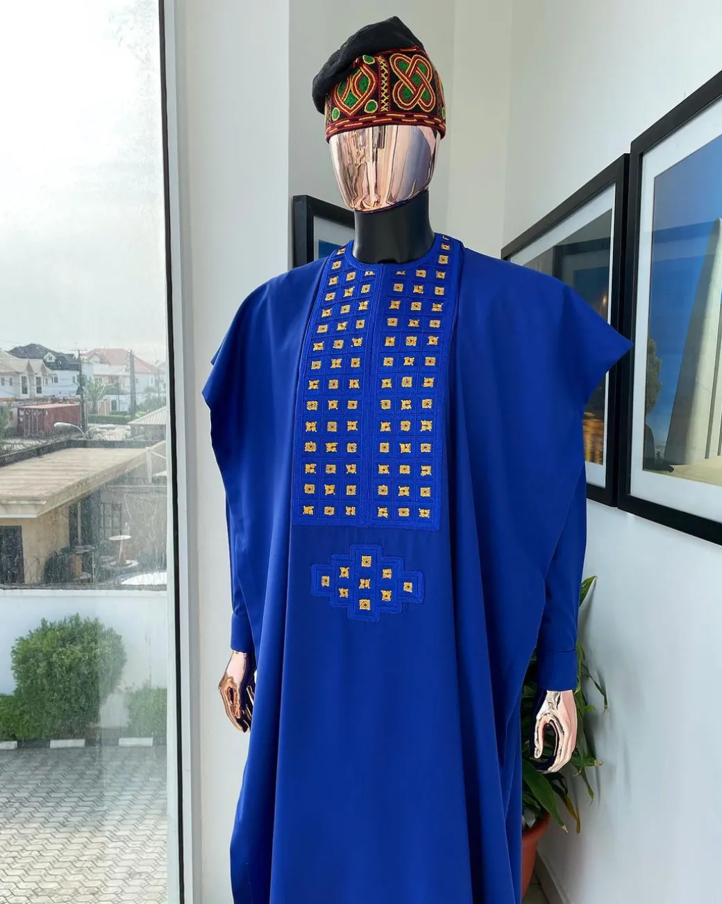 An Azure blue, connected square embroidery design with gold treading & matching Swarovski stone details agbada