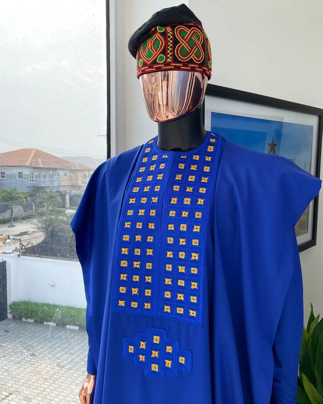 An Azure blue, connected square embroidery design with gold treading & matching Swarovski stone details agbada