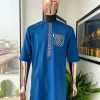 An azure blue, curly 3D embroidery flap and pocket detailing African traditional senator kaftan native