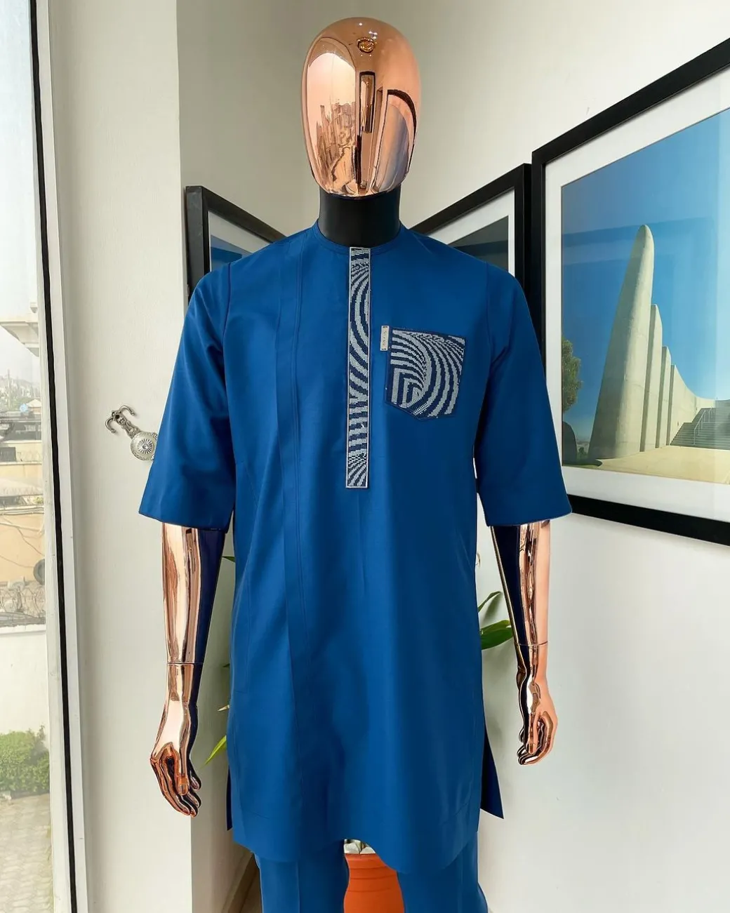 An azure blue, curly 3D embroidery flap and pocket detailing African traditional senator kaftan native