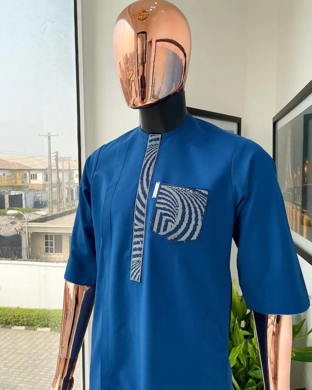 An azure blue, curly 3D embroidery flap and pocket detailing African traditional senator kaftan native