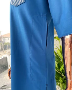 An azure blue, curly 3D embroidery flap and pocket detailing African traditional senator kaftan native