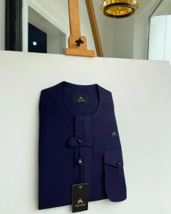 An Eggplant purple, combat front flap and pocket with a black Swarovski button detailing African traditional senator kaftan native.