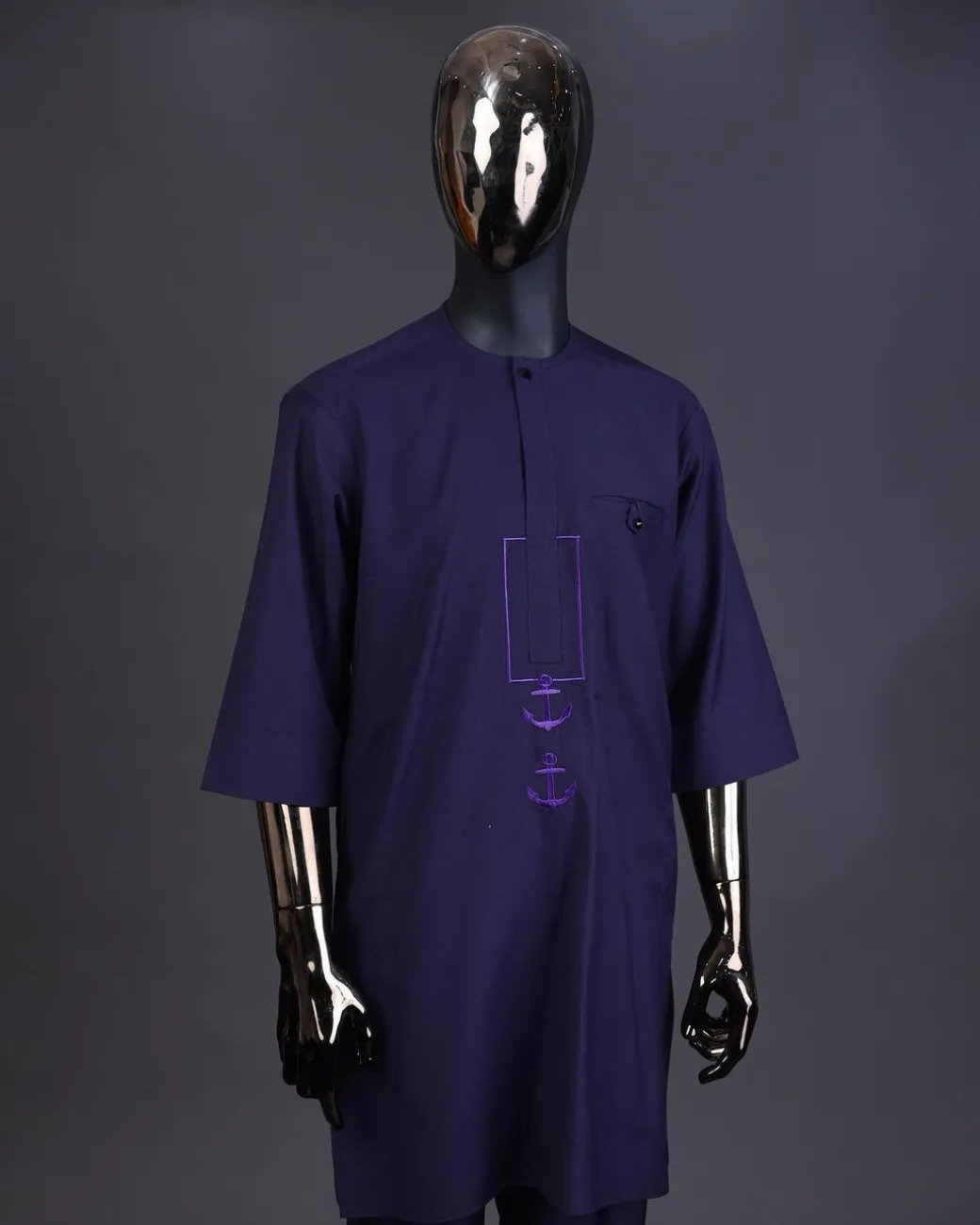 An eggplant purple, front flap with black Swarovski button, square and anchor embroidery detailing kaftan and Sokoto