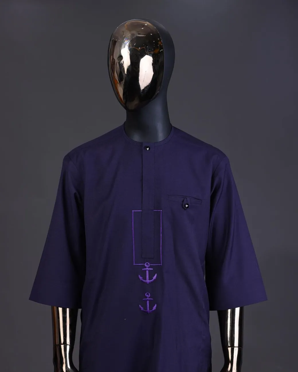 An eggplant purple, front flap with black Swarovski button, square and anchor embroidery detailing kaftan and Sokoto