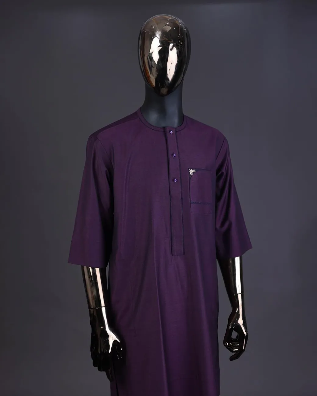 An eggplant purple front flap with matching Swarovski button detailing kaftan and Sokoto