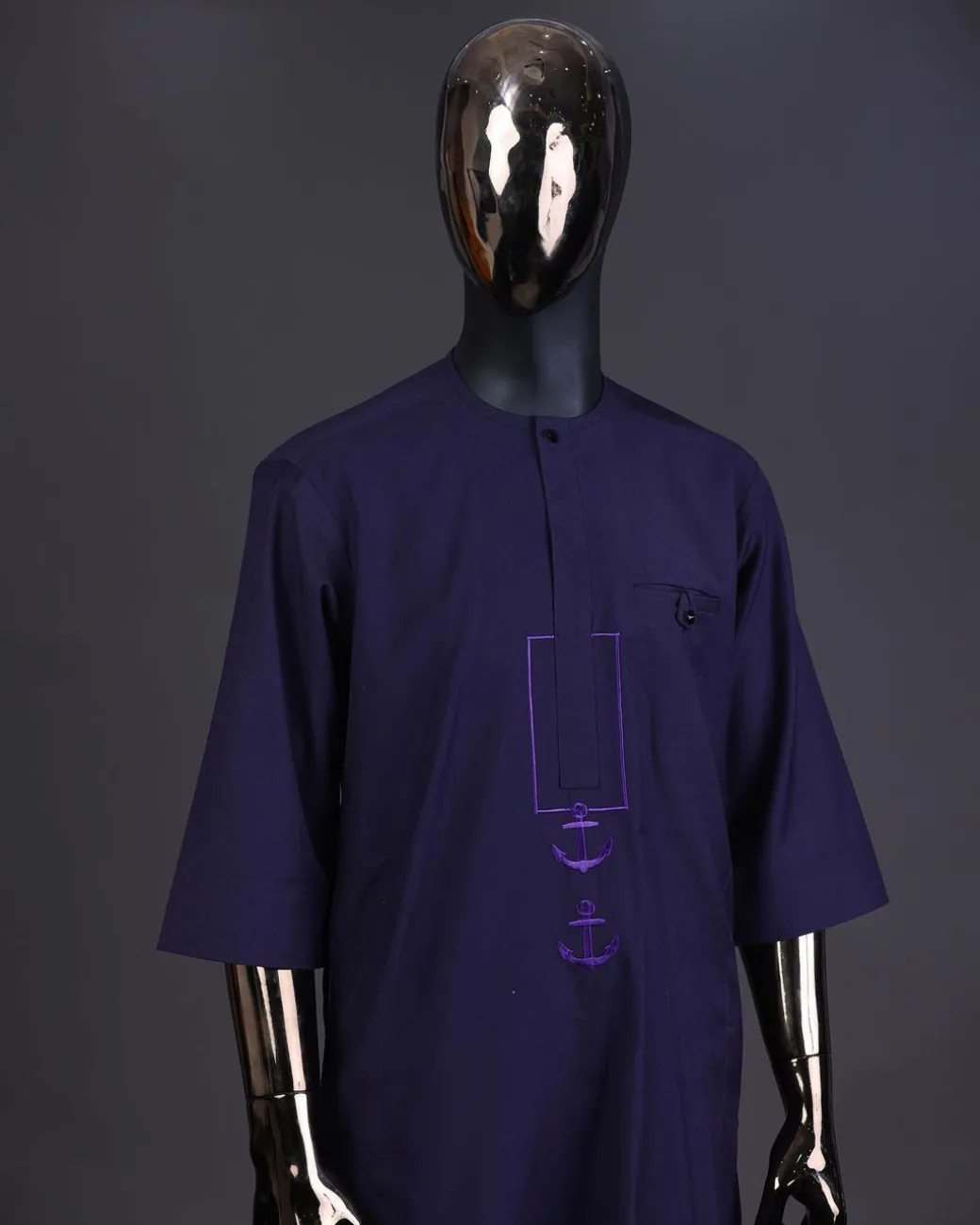 An eggplant purple, front flap with black Swarovski button, square and anchor embroidery detailing kaftan and Sokoto