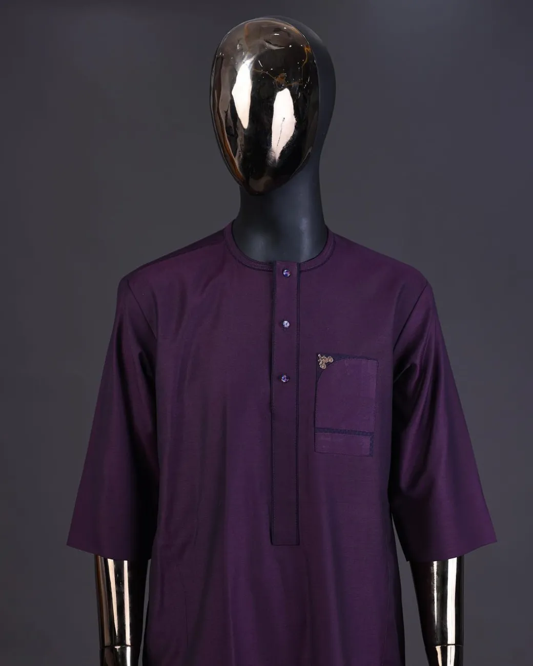 An eggplant purple front flap with matching Swarovski button detailing kaftan and Sokoto
