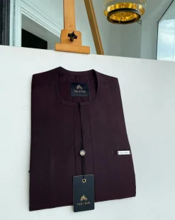 An eggplant purple, mid-section front flap, and piped pocket African traditional kaftan native