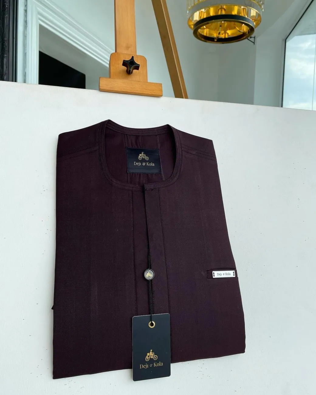 An eggplant purple, mid-section front flap, and piped pocket African traditional kaftan native