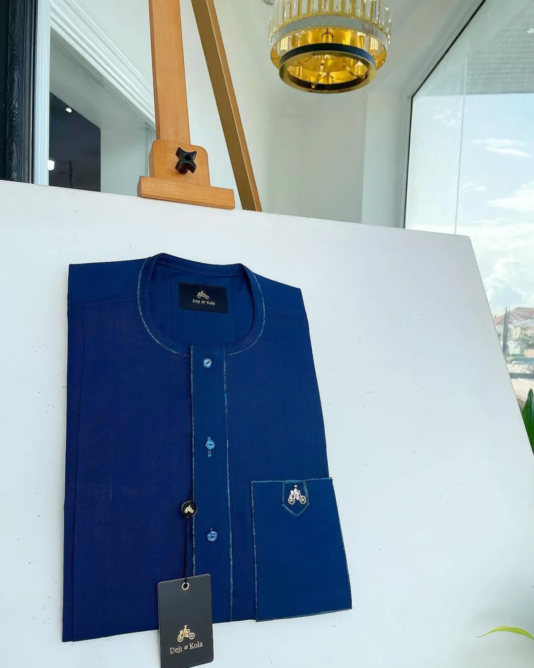 An Egyptian blue, front flap, patch pocket, matching Swarovski buttons, paisley detailing African senator kaftan native.