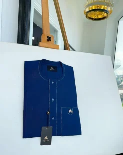 An Egyptian blue, front flap, patch pocket, matching Swarovski buttons, paisley detailing African senator kaftan native.