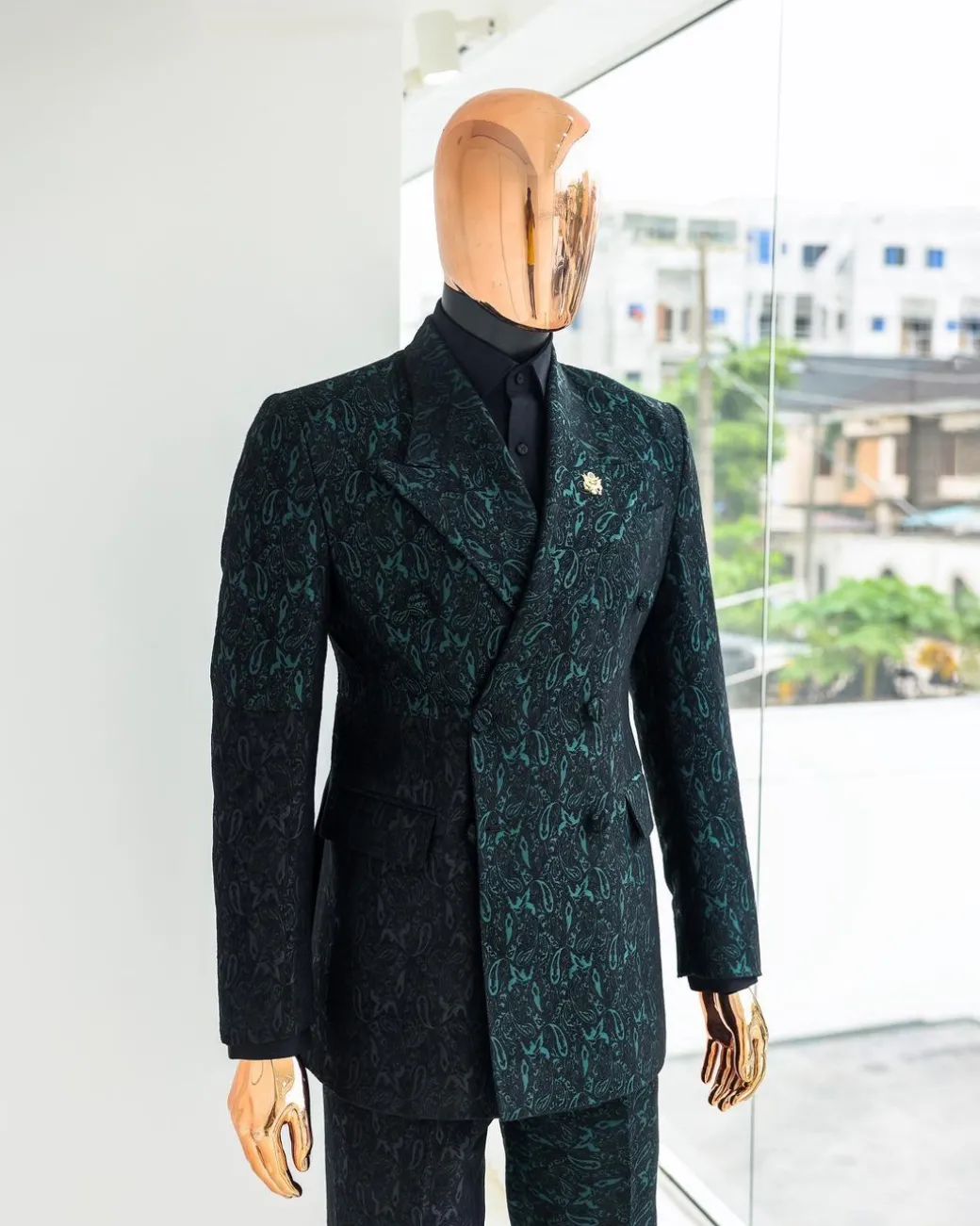 An Emerald green & black “rival” 1/4 cut ocean element peak lapel double breasted jacquard suit.
