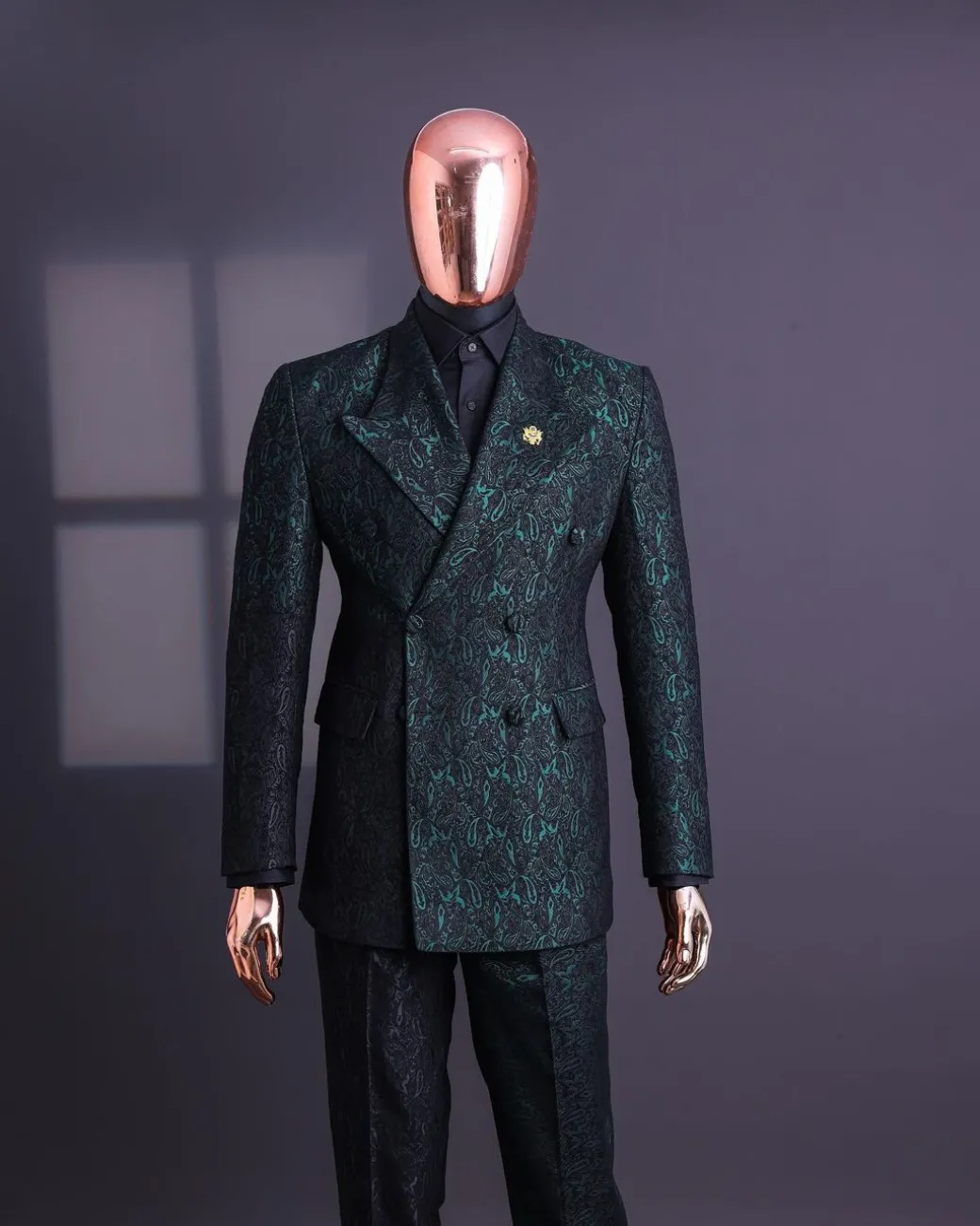 An Emerald green & black “rival” 1/4 cut ocean element peak lapel double breasted jacquard suit.