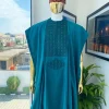 An emerald green, connected square embroidery design with matching green and red Swarovski stone details agbada