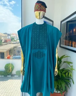 An emerald green, connected square embroidery design with matching green and red Swarovski stone details agbada