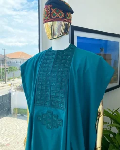 An emerald green, connected square embroidery design with matching green and red Swarovski stone details agbada