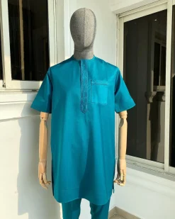 An emerald green front flap and traditional embroidery senator kaftan
