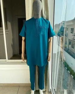 An emerald green front flap and traditional embroidery senator kaftan