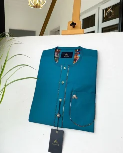 An emerald green with a Swarovski stone button and lower cylinder-shaped African Kaftan