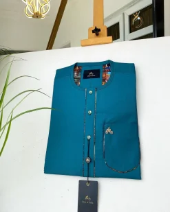An emerald green with a Swarovski stone button and lower cylinder-shaped African Kaftan