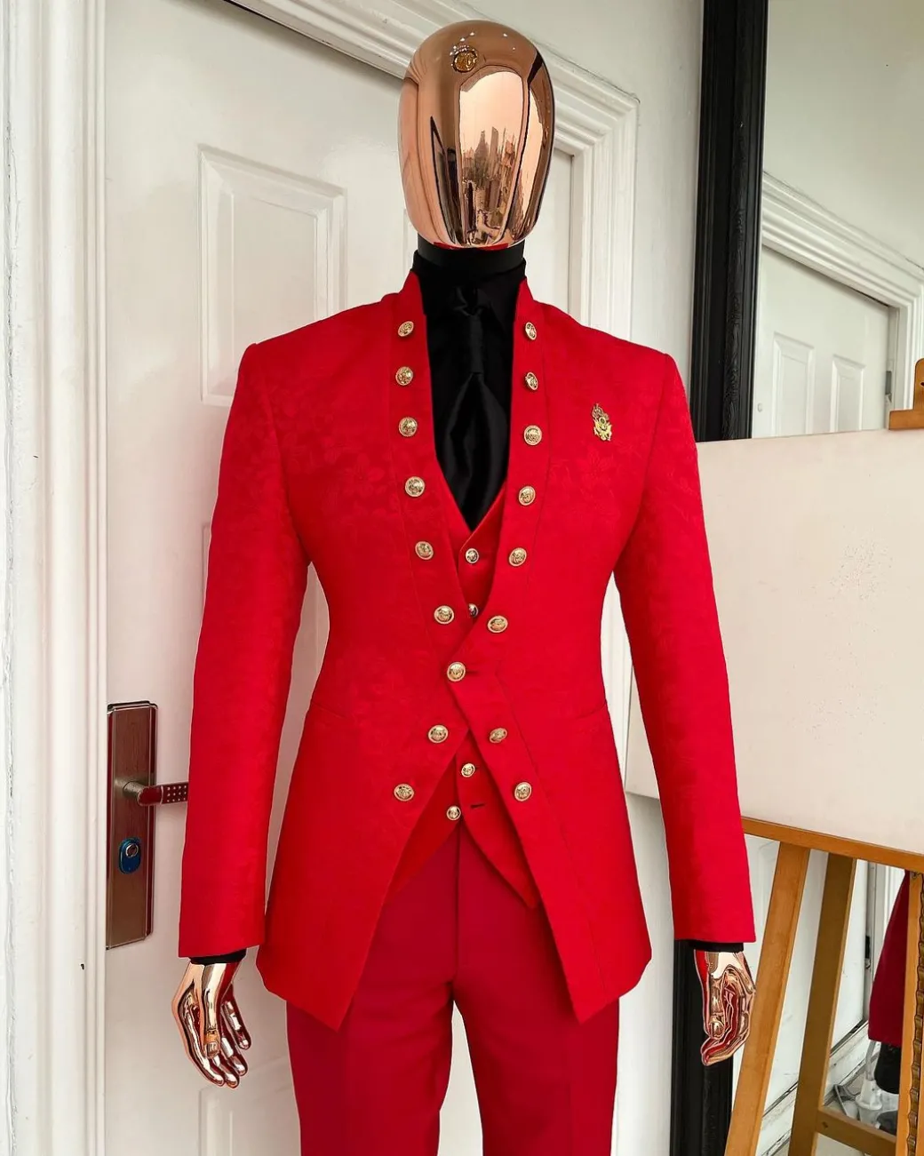 An “empire” candy red, floral patterned metallic jacquard suit
