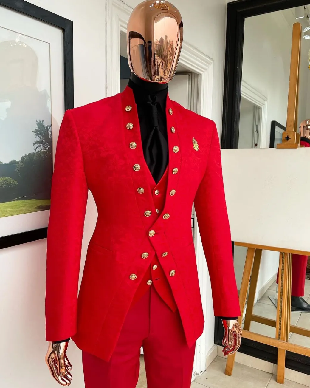 An “empire” candy red, floral patterned metallic jacquard suit