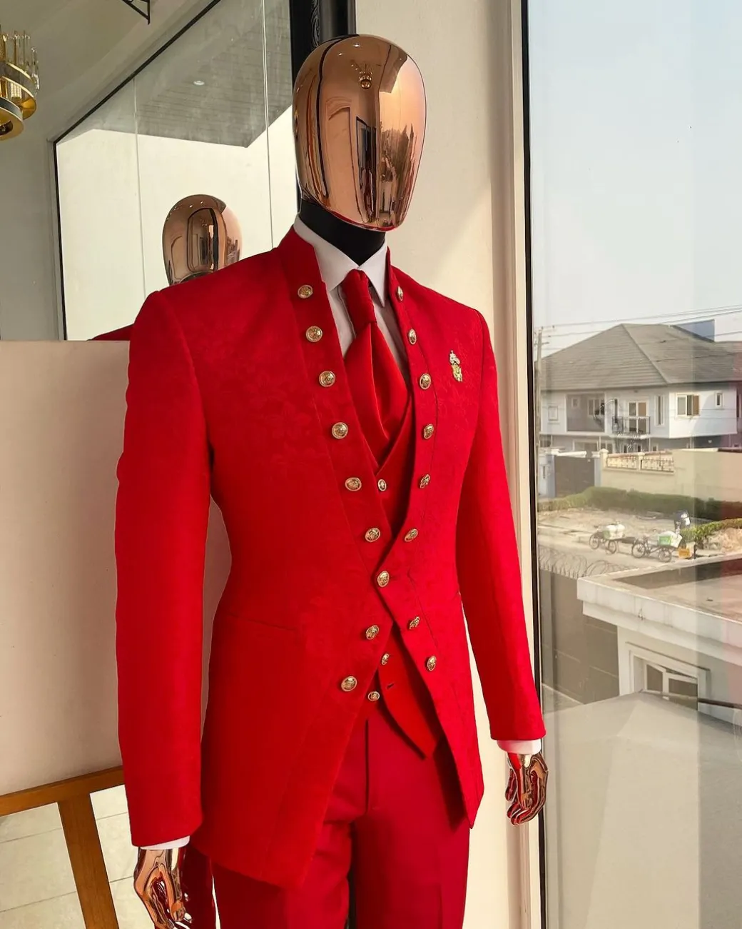 An “Empire” candy red, floral patterned metallic jacquard suit