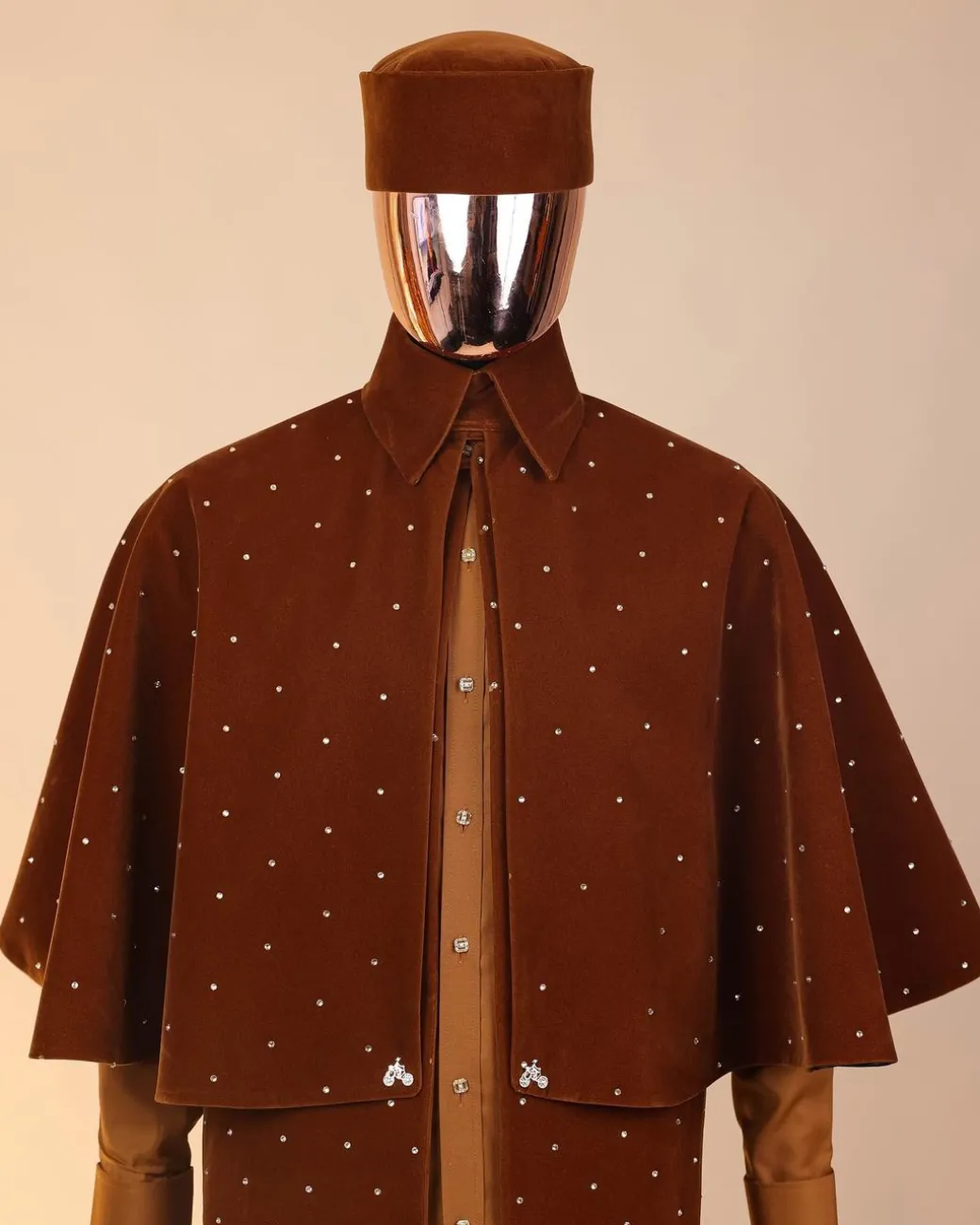 An “Eyes Wide Shut” syrup brown Italian velvet Ceremonial suktan with gold crystals Swarovski stone