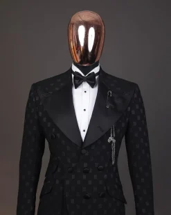 An Inverted “Pirate”, knitted, charcoal black with distributed square pattern jacquard peak lapel, 9 button tuxedo suit.
