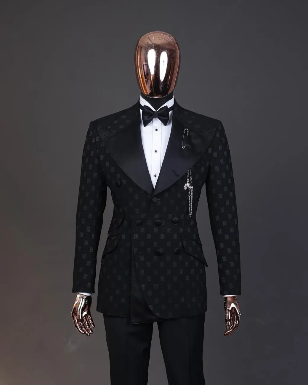 An Inverted “Pirate”, knitted, charcoal black with distributed square pattern jacquard peak lapel, 9 button tuxedo suit.