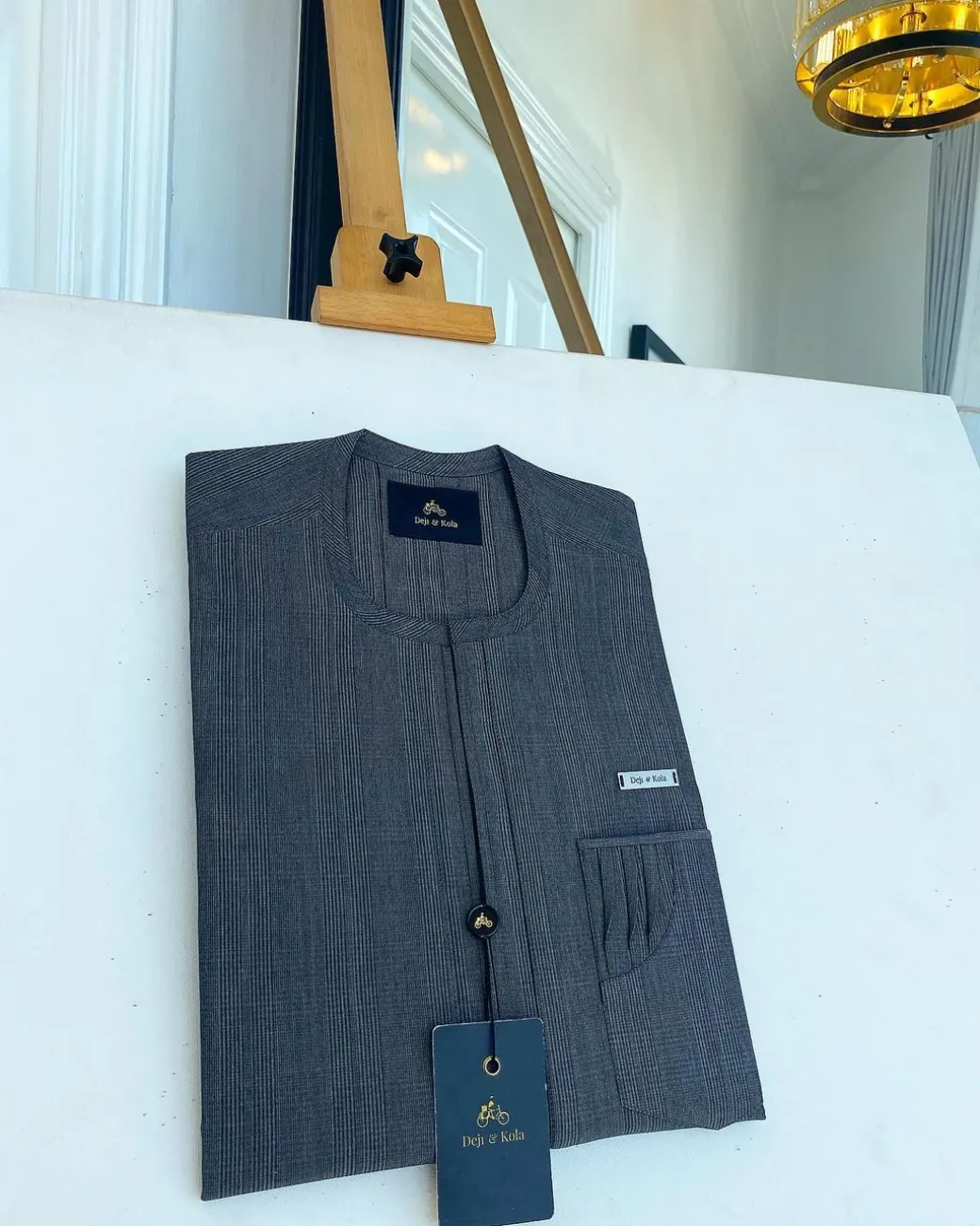 An invisible windowpane grey check, single pocket, front flap African traditional senator kaftan native.