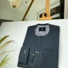 An Irish Grey African kaftan with a black Swarovski button and metal detailing