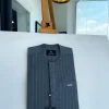 An iron-grey pencil stripe, front flap, and slant pocket detail Senator Kaftan native