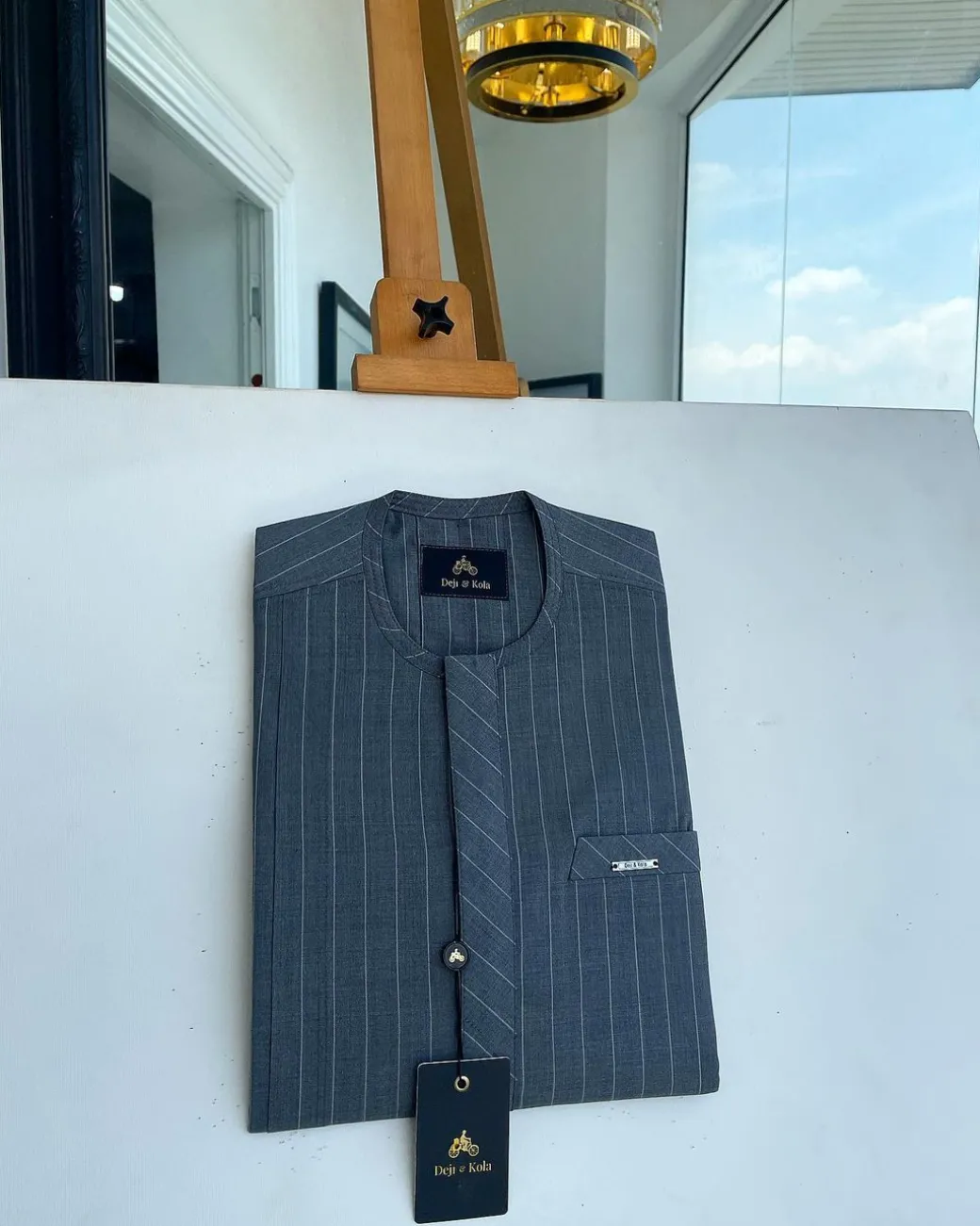 An iron-grey pencil stripe, front flap, and slant pocket detail Senator Kaftan native