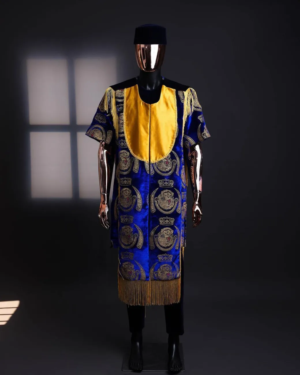 An “Isiagba” gold, blue with matching fringe details, short sleeve top & velvet pant African traditional native.
